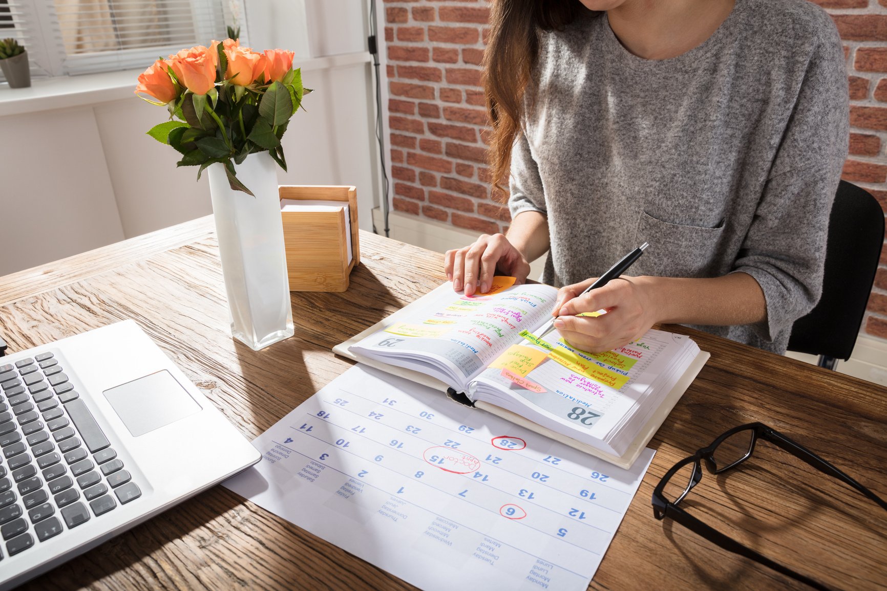 Woman Writing on a Planner 